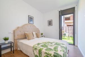 a bedroom with a large bed with a large window at Jouvacations Villa Osona in Vilafant
