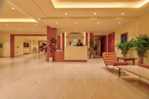 eine Lobby mit Rezeption und Menschen in einem Gebäude in der Unterkunft Dwellr Luxury Stays - Golf Course Road in Gurgaon