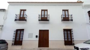 a white building with doors and balconies on it at CASTRO Suites Osuna in Osuna