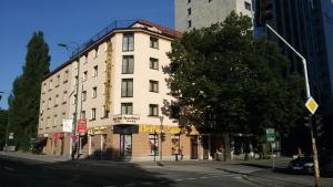 a tall white building on a city street with a tree at Hotel Boutique Bristol in Sarajevo