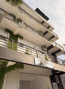 a building with a balcony with plants on it at City Hotel Thalawathugoda in Talawatugoda +12 photos