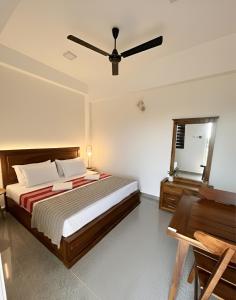 a bedroom with a bed and a ceiling fan at City Hotel Thalawathugoda in Talawatugoda