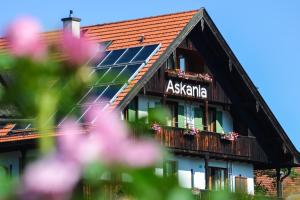 a building with a balcony with flowers in front of it at Hotel Askania 1927 in Bad Wiessee