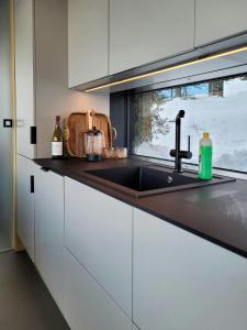 a kitchen counter with a sink and a window at Modern Cabin At Blefjell in Svene