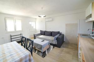 a living room with a couch and a table at Apartman Šarabaća in Bajagić +17 photos
