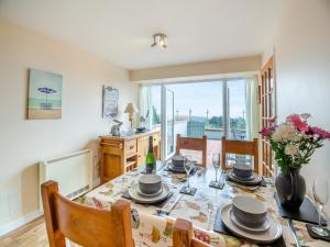 a dining room with a table and chairs at Golygfa Hudol - Uk46712 in Pwllheli