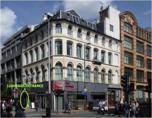 a large white building on the corner of a street at Lushpads in Manchester