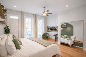 a bedroom with a large bed and a living room at Remodeled Modern Home - private backyard & games! in Louisville