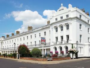 a white building with a sign on top of it at Anglesey Hotel in Gosport