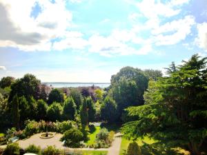 
a scenic view of a beach with trees at Anglesey Hotel in Gosport
