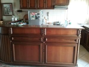 a kitchen with a wooden island with a counter top at Maisonette Afroditi in Perea