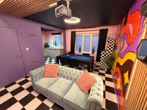 a living room with a couch and a pool table at Capsule illusion - Switch 2 - Mons Centre in Mons +63 photos