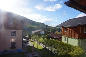 a view of a house with a mountain in the background at Apartment Voorhorst in Wagrain