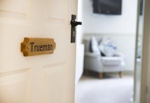 a refrigerator with a sign on the door at The Cricket Inn in Kingsbridge +4 photos