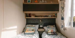 a small bedroom with two beds in it at Serenity in Saint Erth