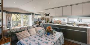 a kitchen and a living room with a couch and a table at Serenity in Saint Erth