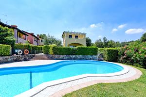 a swimming pool in the yard of a house at Villa Bella by Garda FeWo in Manerba del Garda