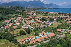 an aerial view of a residential estate next to the water at Villa Bella by Garda FeWo in Manerba del Garda