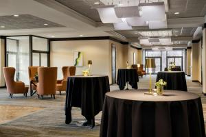 a conference room with two tables and chairs at Wichita Marriott in Wichita