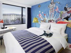 a bedroom with a bed with a teddy bear on it at 25hours Hotel beim MuseumsQuartier in Vienna +77 photos