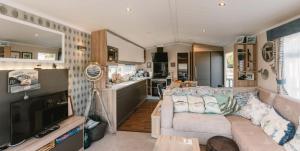 a living room and kitchen of a caravan at Serenity in Saint Erth +23 photos