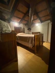 a bedroom with a bed in a room with wooden ceilings at Agriturismo Giorgio Colutta in Manzano +54 photos