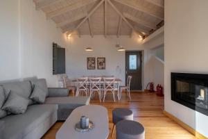 a living room with a couch and a table at Dio Escapes Villas in Poulithra