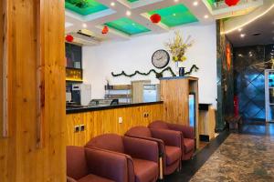 a waiting room with brown chairs and a counter at Smart Hotel Thamrin Jakarta in Jakarta