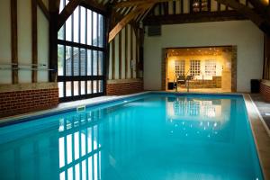 a swimming pool with blue water in a building at Finest Retreats - Oasis 41 in Fritton