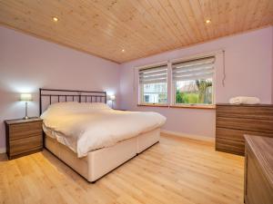 a bedroom with a large bed and a window at Finest Retreats - Oasis 41 in Fritton +29 photos