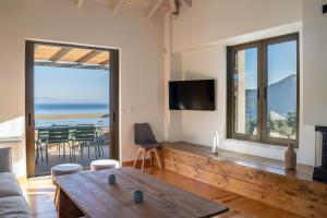 a living room with a couch and a table at Dio Escapes Villas in Poulithra
