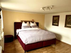 a bedroom with a large bed with white sheets at Ferienwohnung "Am Malerweg" Lohmen in Lohmen +16 photos