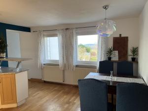 a living room with a table and a window at Ferienwohnung "Am Malerweg" Lohmen in Lohmen
