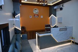 a living room with a couch and a bar at Hotel Radhe in Bhind