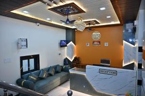 a waiting room with a couch and a table at Hotel Radhe in Bhind
