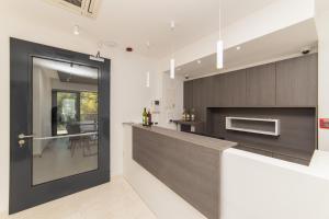a kitchen with a black door and a dining room at Inamore in Gradac