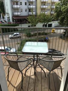 a table and two chairs on a balcony at APARTHOTEL 1A in Zwickau