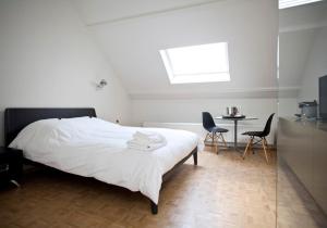 a bedroom with a bed and a table and chairs at B&B Yellow Submarine in Antwerp