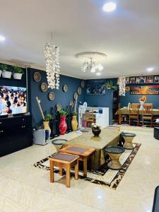 a living room with a table and a tv at Esther Villas Home in Boma la Ngombe
