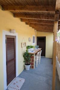 a patio with a table and chairs in a house at Rodi House in Lygia