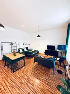 a living room with couches and tables and a piano at Apartmán na Žerotínce in Šumperk