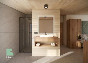 een badkamer met een wastafel en een spiegel bij Kitzhorn Suites in Sankt Johann in Tirol +16 foto's