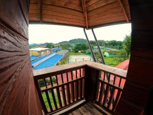 a room with a balcony with a view of a pool at Petra Hotel in Nuquí