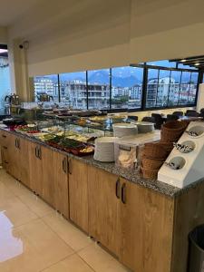 a buffet line with plates and food on it at Döşemealtı Konfor Hotel in Dosemealti