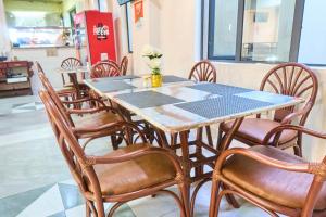 a table and chairs in a restaurant with flowers on it at Eliper Hotel in Gatura