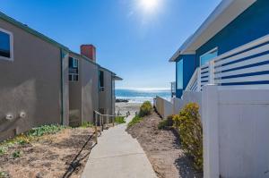 a sidewalk next to a house and the beach at Beach Bum Retreat in Cayucos
