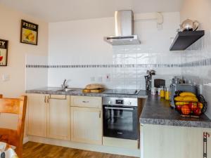 a kitchen with a sink and a stove top oven at Golygfa Hudol - Uk46712 in Pwllheli
