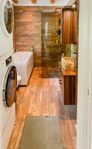 a bathroom with a sink and a washing machine at Modern Log Cabin On Adelsö in Adelsö +7 photos