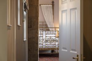 an open door to a room with a bed in the background at King William in Bath