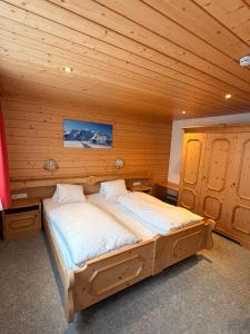a bedroom with a bed in a wooden room at Damülser Horn in Damuls